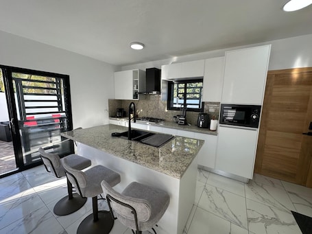 Private kitchen. Charming El Cercado Villa - Spacious Modern 3BR with AC- Family Friendly