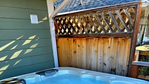 A hot tub with a wooden deck and a metal ladder. - Charming Bungalow • Hot Tub • Near Trails & Dining (Ogden)