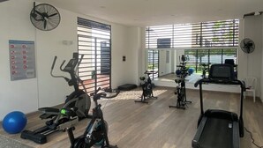 A gym with treadmills, stationary bikes, and exercise balls. - Cozy 2-bedroom apartment in gorgeous Ricaurte with AC and gym (Ricaurte)