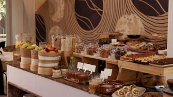 A buffet with various food items and beverages.