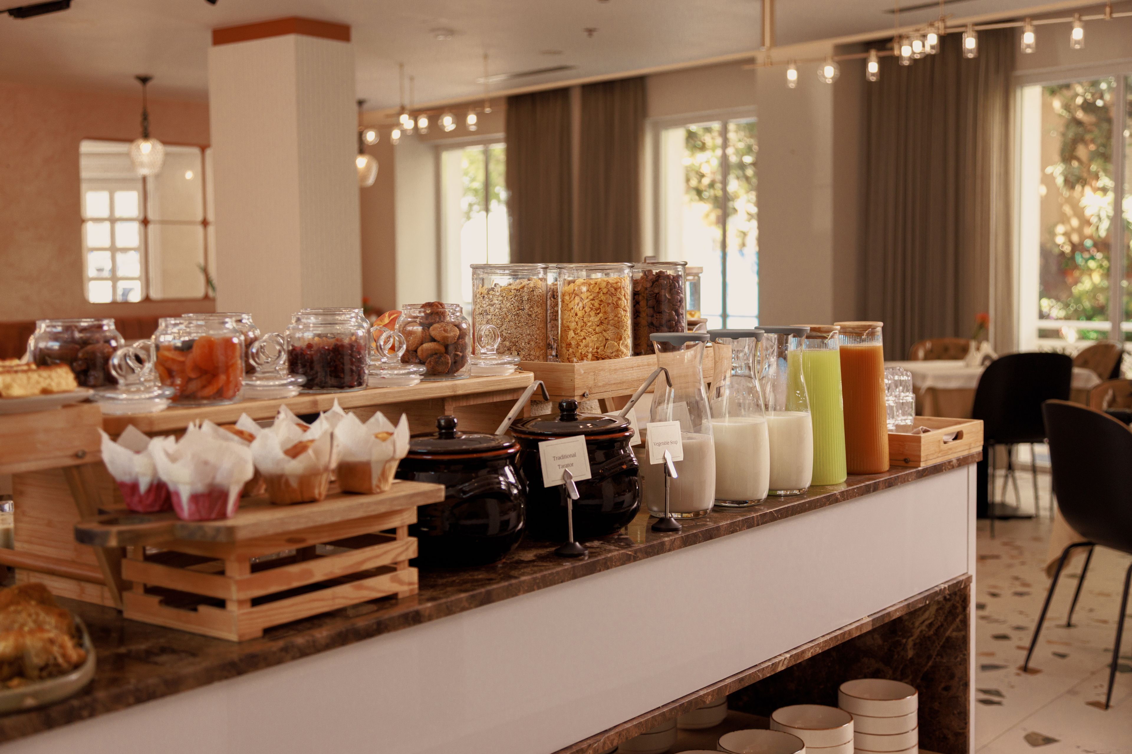 A breakfast bar with various food items and beverages.