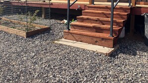 A building with a red roof, wooden steps, and a metal railing. - Sunny & Private I bedroom House with Sun Room for Guests (Torrey)