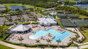 An aerial view of a resort with a large swimming pool, tennis courts, and a golf course. - Perfect getaway in SouthWest Florida (Punta Gorda)