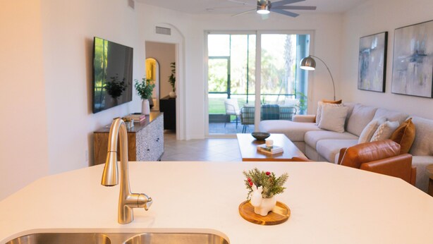 A modern kitchen with a stainless steel sink, a ceiling fan, and pendant lighting. - Perfect getaway in SouthWest Florida (Punta Gorda)