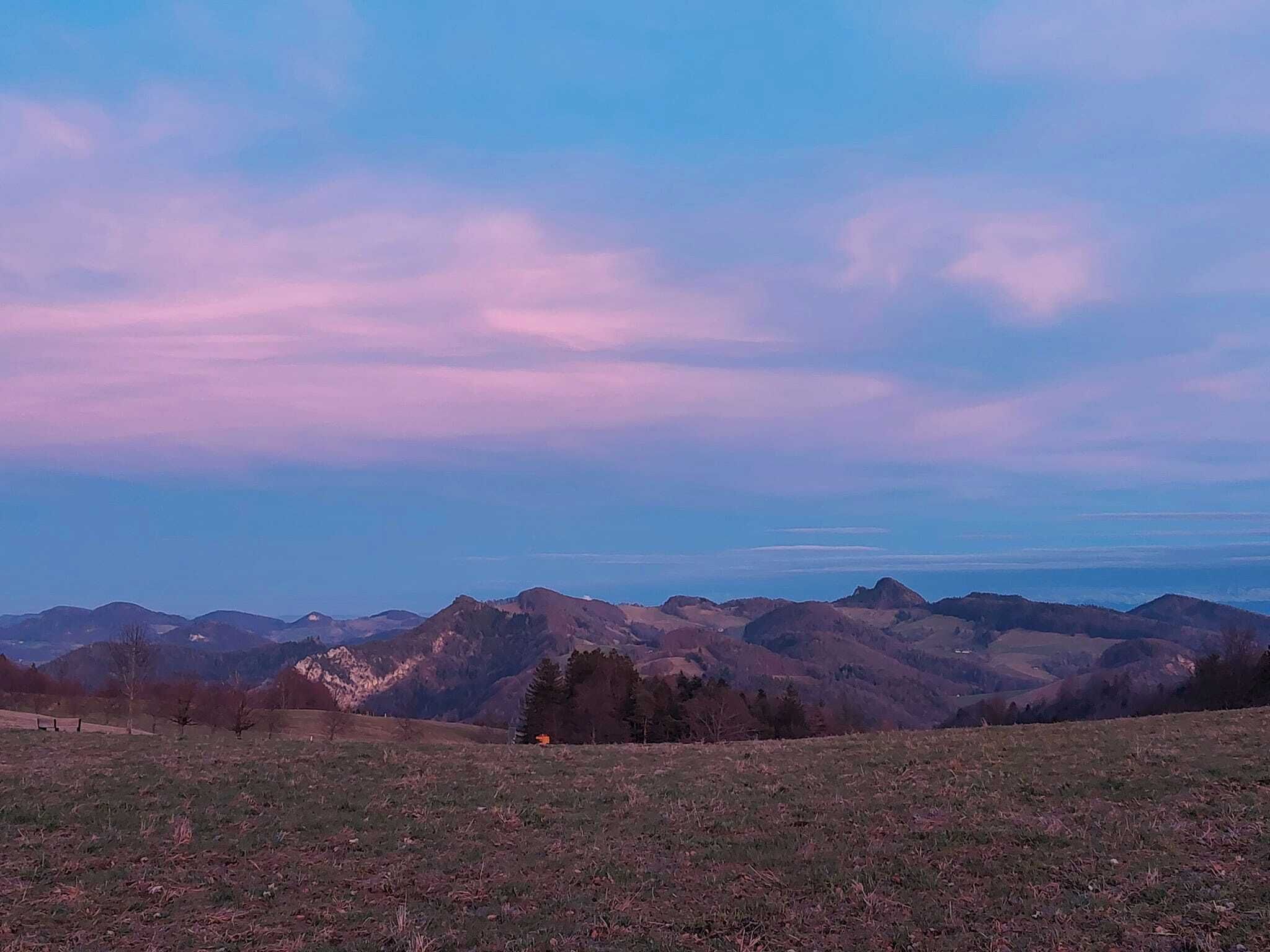 A panoramic view of a mountainous landscape with a clear sky.