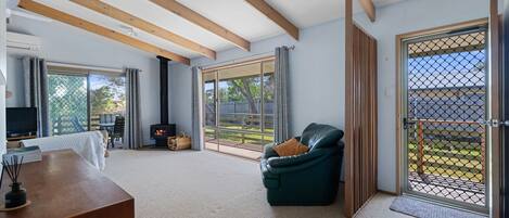 A spacious living room with a fireplace, a sofa, and a TV.