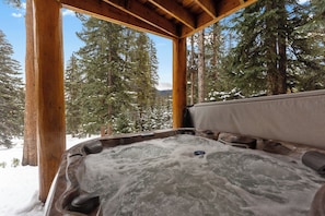 A hot tub with a wooden frame and a view of snow-covered trees and mountains. - 14mcbr3 (Breckenridge)