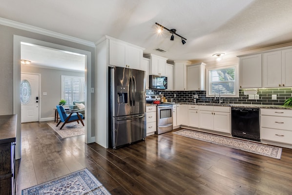 Microwave, oven, stovetop, dishwasher - Walkable Downtown Cottage  2 King Beds & Deck (McKinney)