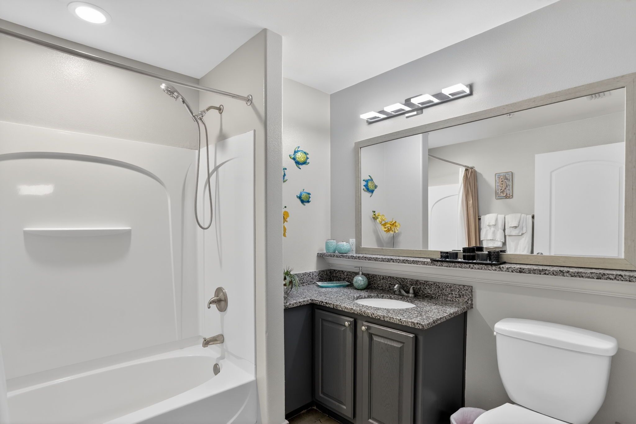 A bathroom with a bathtub, a sink, and a toilet.