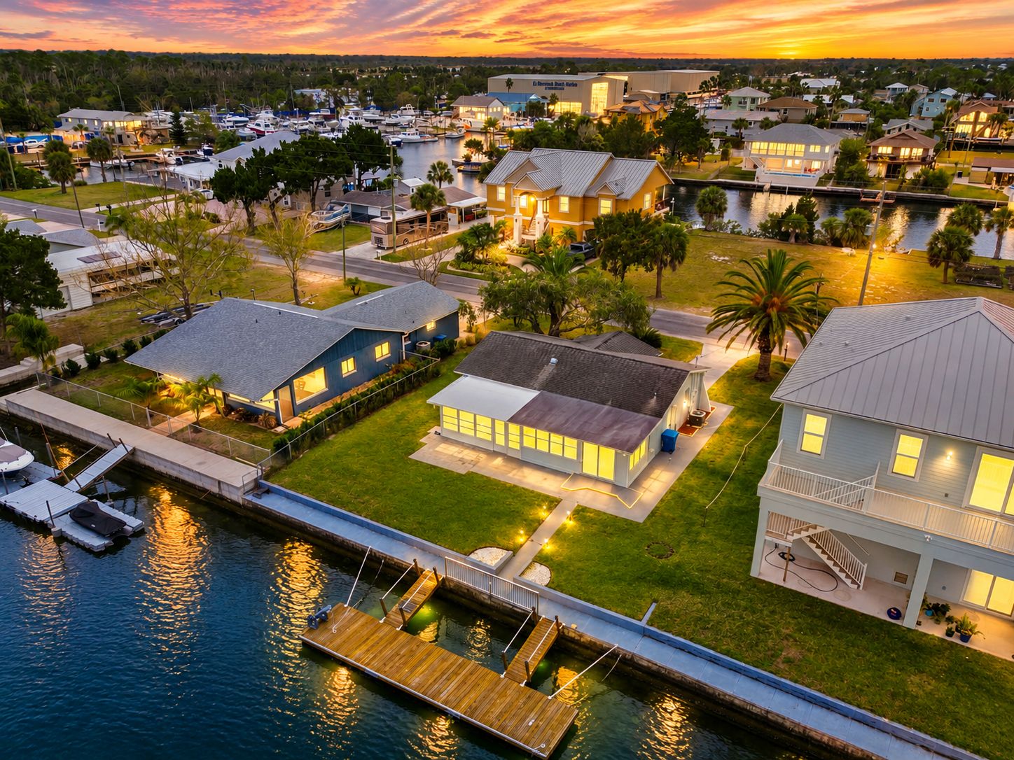 A residential area with houses, a marina, and a dock.