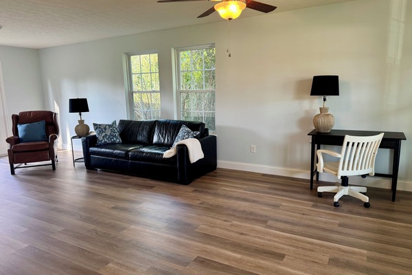 Family room area located on main floor with TV and dedicated work space.