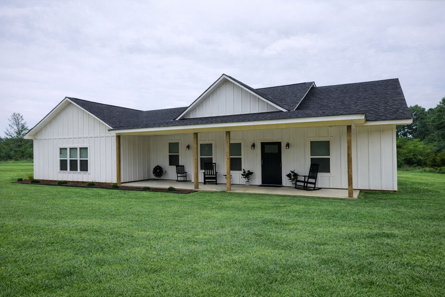 A single-story house with a covered porch, a front door, and a small front yard.