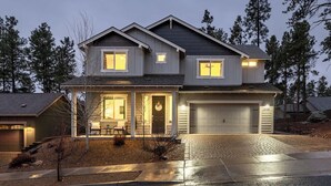 A two-story house with a garage, a covered porch, and a driveway. - 5BR Flagstaff Forest Home Mountain Retreat (Flagstaff)