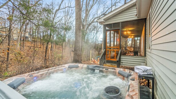 A hot tub in a wooded area with a house in the background. - *NEW* Movie-themed, Speakeasy, Theatre, Games, HotTub, Pets (McGaheysville)