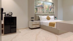 A modern bedroom with a large bed, a nightstand, a coffee maker, and a decorative wall mural. - JBM RESORTS & WATER PARK (Abohar)