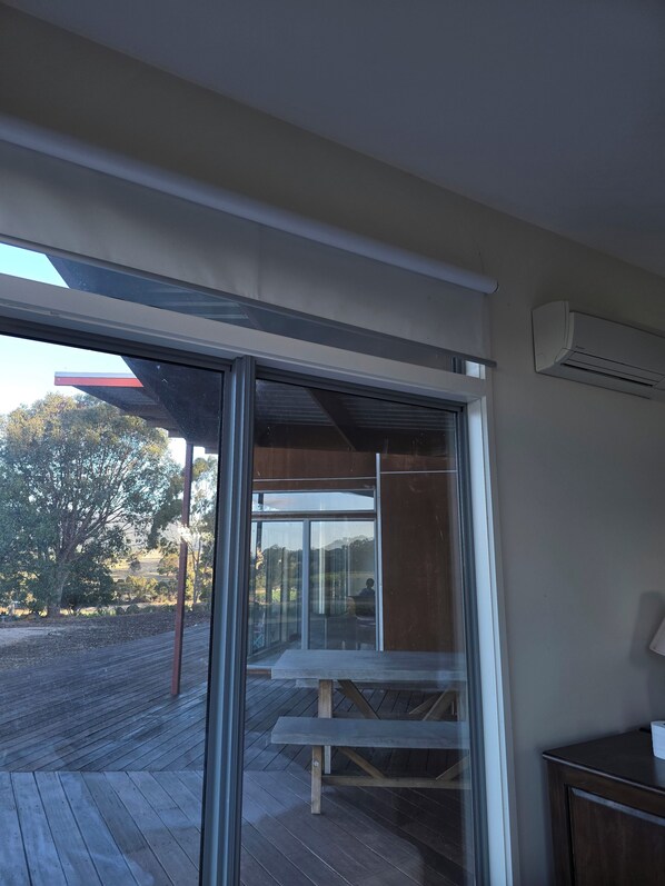 A room with a large sliding glass door leading to an outdoor deck.