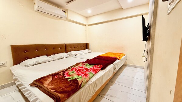 Deluxe Quadruple Room | Premium bedding, desk, laptop workspace, soundproofing - Hotel A Grand near All Main Places (Ujjain)