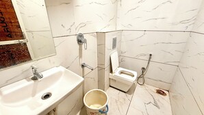 A bathroom with a sink, toilet, and shower. - Hotel A Grand near All Main Places  (Ujjain)