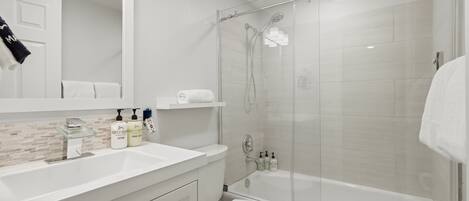 Shower, hair dryer, towels, shampoo