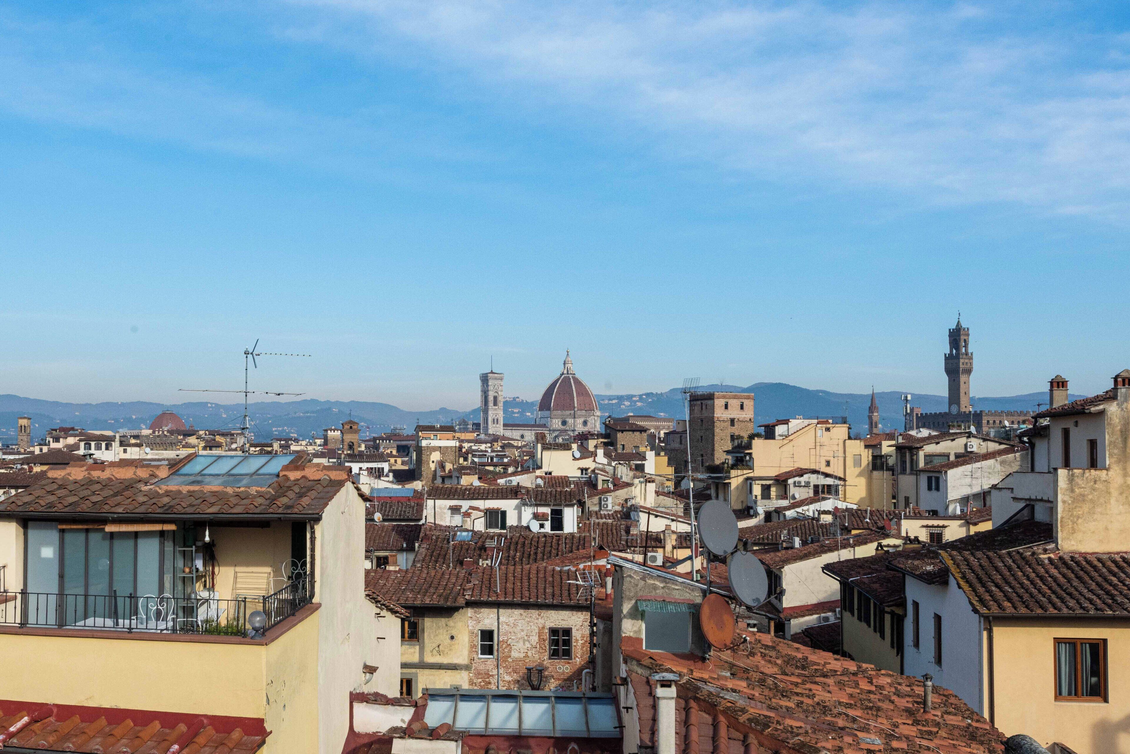 A densely packed urban area with historical architecture, including a prominent dome and tower.