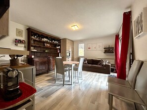 A compact living space with a kitchen area, dining table, and seating area. - 3-room apartment with garden and parking, Briançon (Briançon)