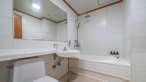 A bathroom with a toilet, sink, and bathtub. - Hotel Lisa (Donghae)