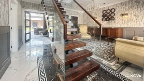 A modern interior with a glass staircase, marble flooring, and a chandelier. - Elegant family home, 2x jacuzzi corner baths, Contract Workers and NHS Welcome. (Luton)
