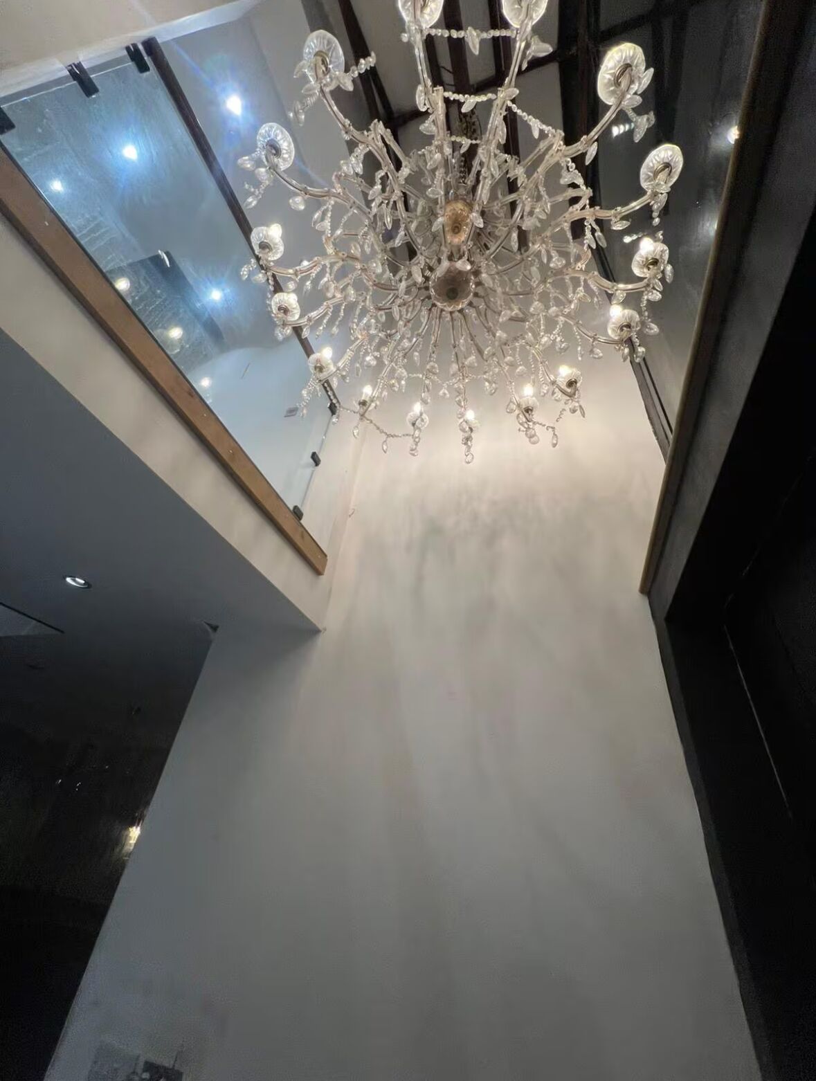 A modern interior with a large, ornate chandelier hanging from the ceiling.