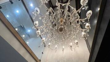 A modern interior with a large, ornate chandelier hanging from the ceiling.