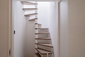 A spiral staircase in a hallway.