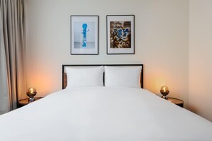 A neatly made bed with white linens, two framed artworks on the wall, and bedside lamps on either side. - w Sophisticated 3BR in the Heart of San Rafael (Mexico City)