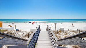 A wooden boardwalk leading to a sandy beach with clear blue water. - New! Beachfront Studio with Covered Balcony, Beach Views, Pool, Tram (Miramar Beach)