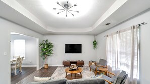A modern living room with a flat-screen TV, a wooden coffee table, and a sofa. - Cozy & Quiet - CENTRAL Location - Master’s Retreat! (Augusta)