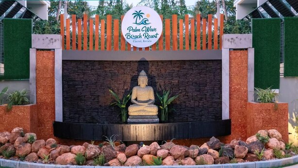 A Buddha statue in front of a sign for Palm Wave Beach Resort in Cherai, Kerala. - Palm Wave Beach Resort (Kochi)