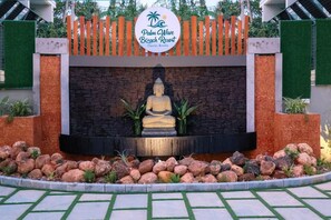 A Buddha statue in front of a sign for Palm Wave Beach Resort in Cherai, Kerala. - Palm Wave Beach Resort (Kochi)