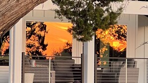 A modern house with a covered porch, a staircase, and a view of trees and a sunset. - LAKE THERAPY- Cozy Lakeside with Beautiful Sunsets! (Temple)