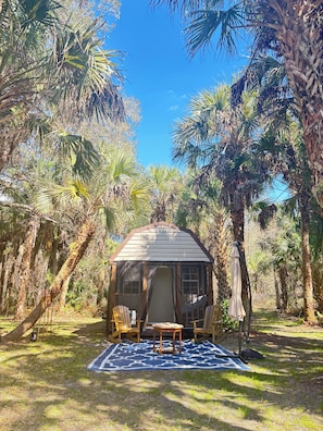 A gazebo with a roof, surrounded by palm trees and a patterned mat on the ground. - CABIN! 1 Private CABIN on 1 Private ACRE of Florida Land. Glamping off-the-grid! (Cocoa)