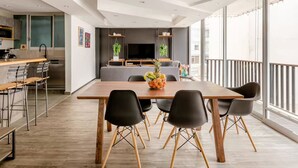 Un appartement moderne comprenant un coin repas, une cuisine et un espace de vie.