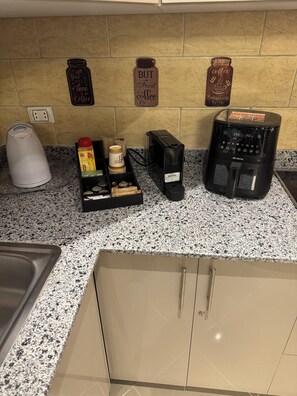A kitchen with a coffee maker, a kettle, and a coffee grinder on the counter. - Sahl Hasheesh Finest Chalet Gravity 5 star beachfront hotel - NON EGYPTIAN ONLY (Hurghada)