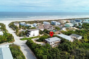 An aerial view of a coastal residential area with houses, a beach, and a clear sky. - Good Vibrations - Steps to the Beach! (St. Augustine)