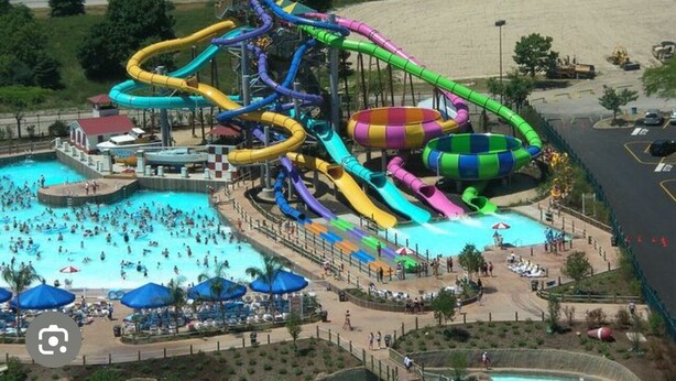 A water park with multiple slides and a swimming pool. - Near AT&T • FIFA & Rangers • Sleeps 8 • Modern Home • Big Yard (Arlington)