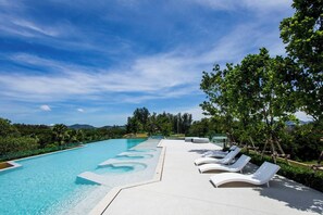 A swimming pool with lounge chairs and a clear sky. - Suite Azure 2br | Laguna beachside bang tao beach (Choeng Thale)