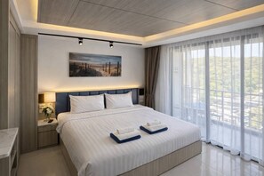 A modern hotel room with a large bed, a nightstand, a painting on the wall, and a view of the outdoors through the window.