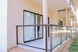A building with a covered outdoor area featuring glass railings and large windows. - Maragogi Beach club (Maragogi)