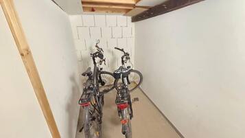 Un pasillo estrecho con dos bicicletas estacionadas contra la pared.