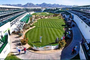 A golf course with a large audience area, a putting green, and a clubhouse. - Modern Oasis, Heated Pool & Spa (Phoenix)
