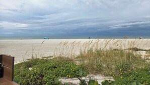 A beach with a sandy shore, some vegetation, and a cloudy sky. - Remodeled 2-bedroom condo in serene Sand Key, Clearwater Beach (Clearwater)