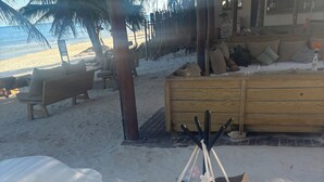A beachside lounge with a sign reading "Rosanegria Beach Day Club" and a wooden bench with a sign that says "Anasasia Tulum". - 2-bedroom apartment in phenomenal Tulum with AC and fitness room (Tulum)
