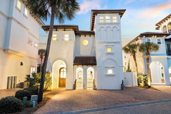 A building with a white facade, multiple arches, and a central tower.