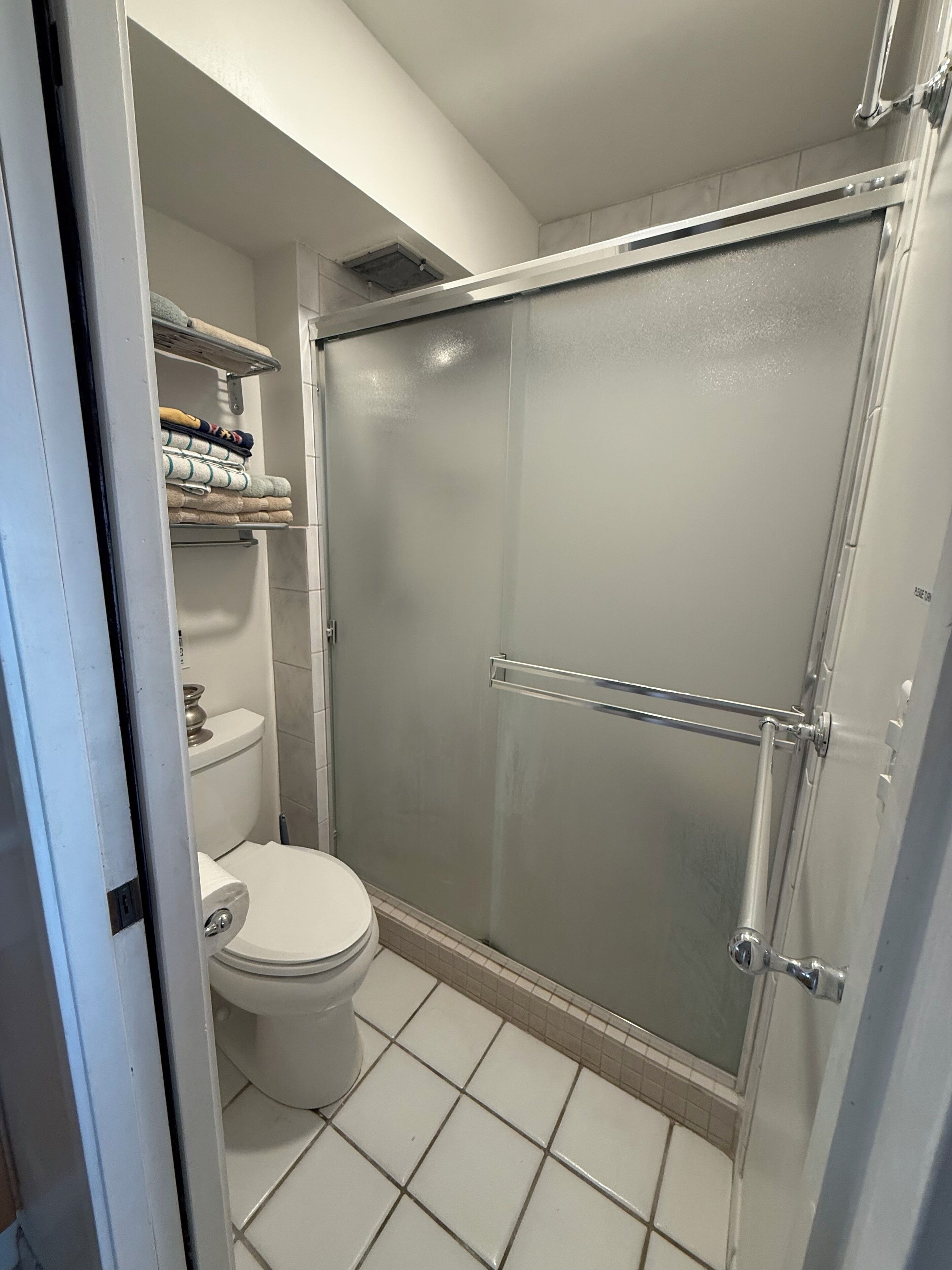 Shower, hair dryer, towels, toilet paper